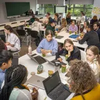 Summer school students working in groups at desks