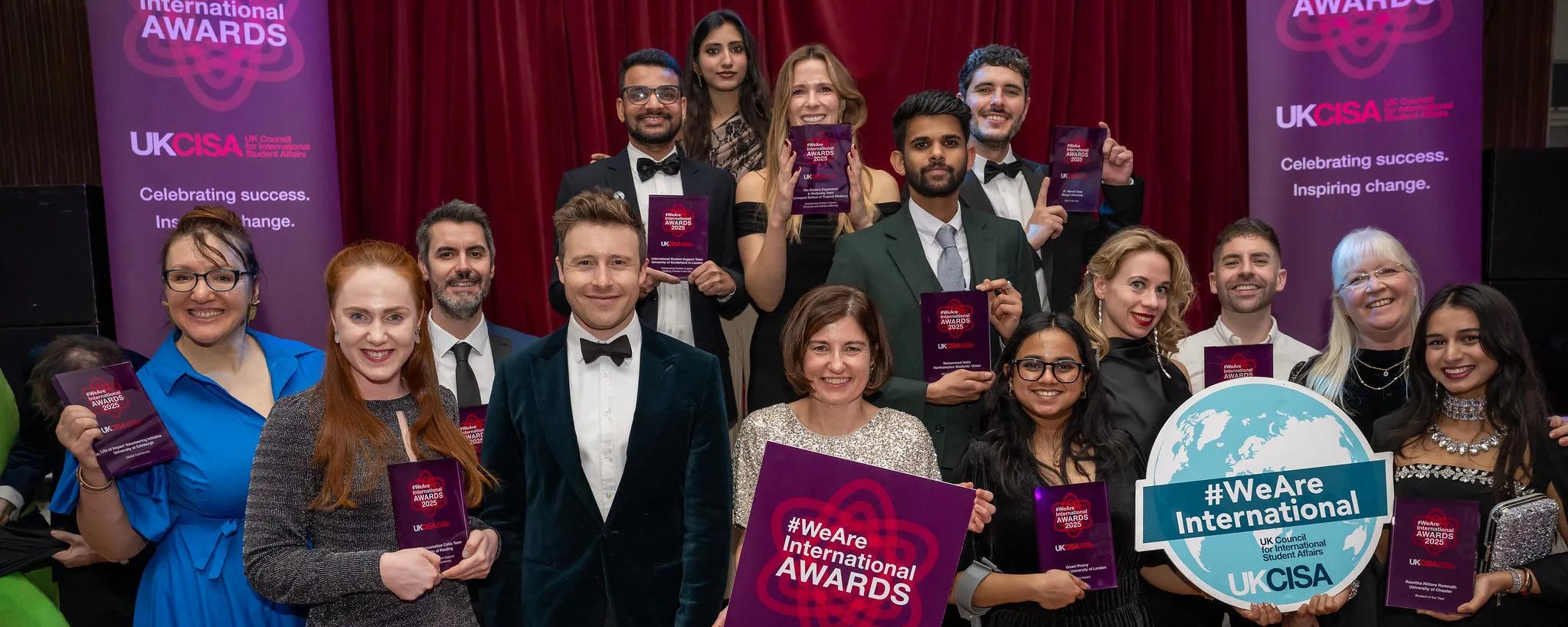 A group of people holding awards and smiling.
